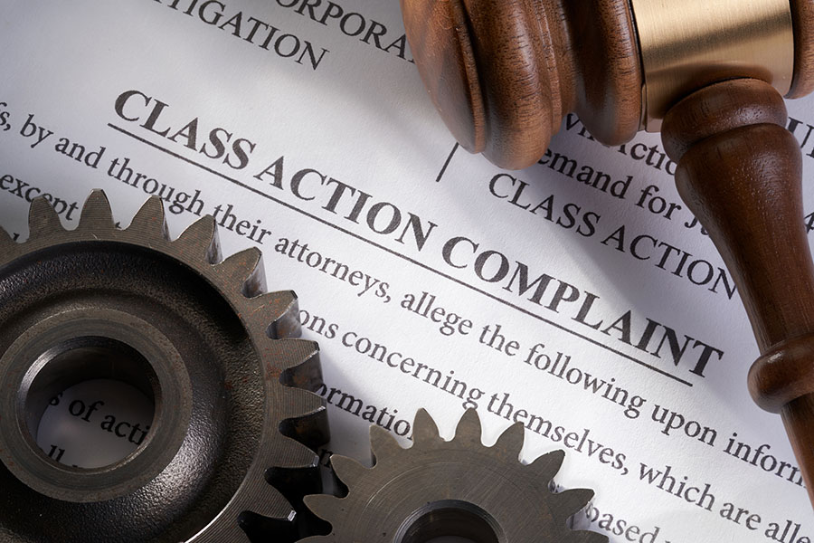 Class action lawsuit document with gears on top