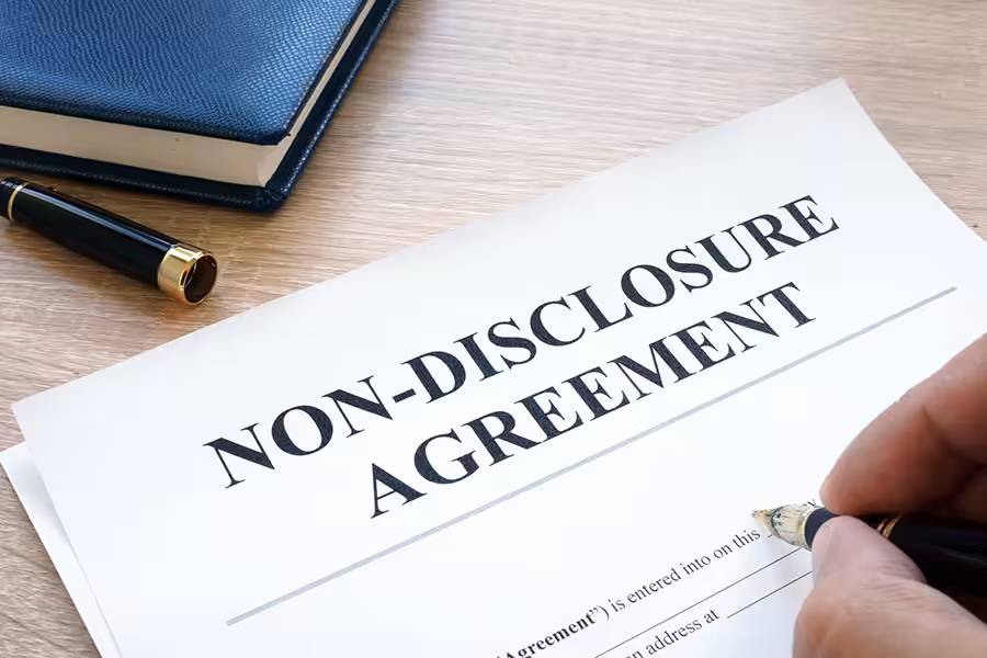 Man is filling in Non-Disclosure Agreement NDA.