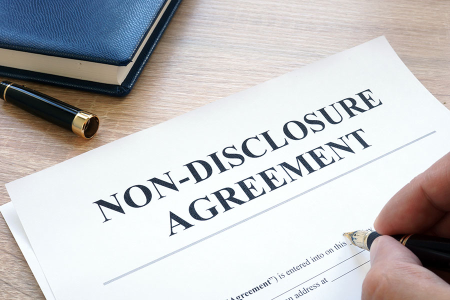 Man is filling in Non-Disclosure Agreement NDA.