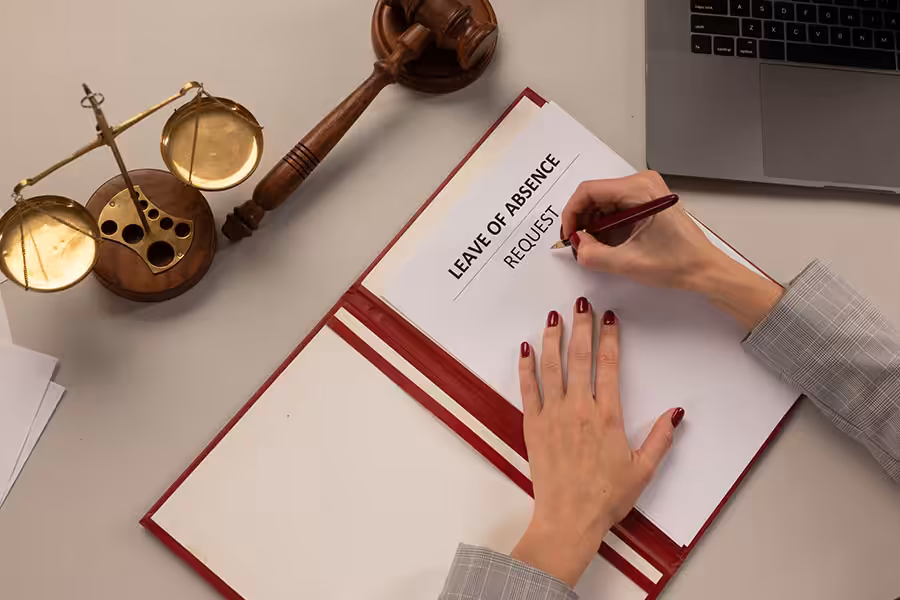 A woman fills out a blank leave of absence request for the Family and Medical Leave Act and the California Family Rights Act.