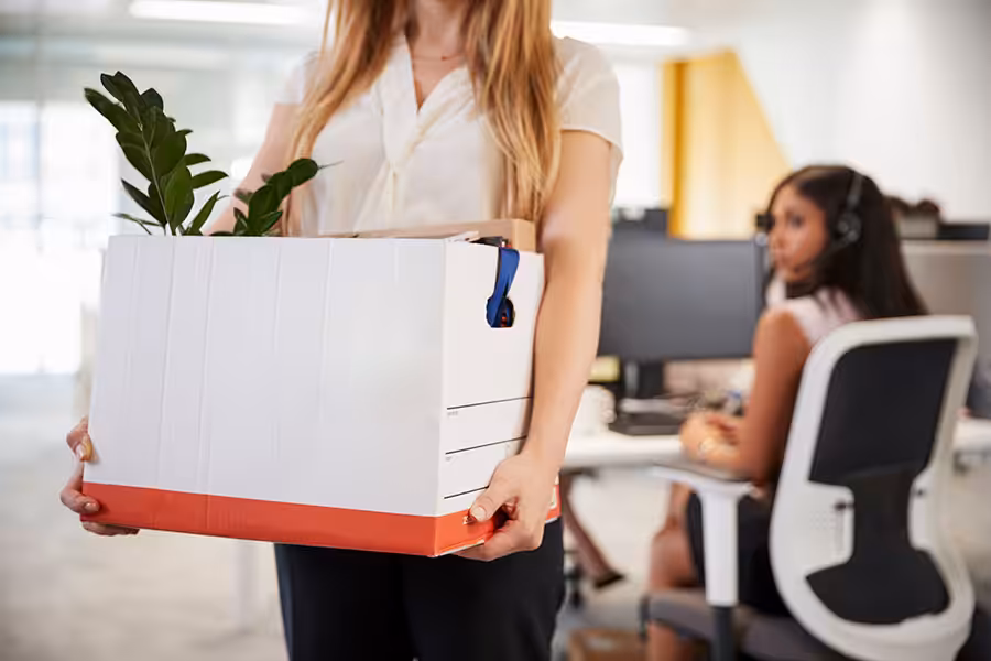 Women holding box after being wrongfully terminated from her job