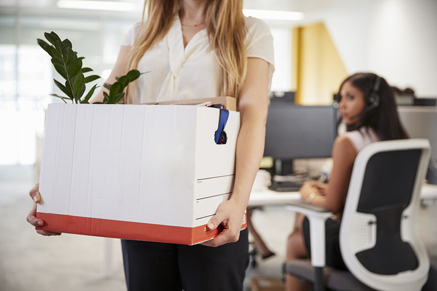 Women holding box after being wrongfully terminated from her job